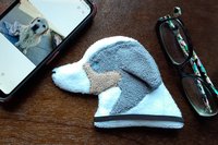 Smudge Dog shown with glasses and phone. Two of the items it can clean.