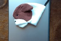 Smudge dog attached to magnetic case on popular tablet