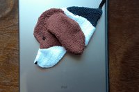 Smudge Dog attached to the magnetic cover of a popular tablet.