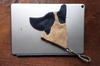 Smudge Dog attached to the magnetic cover of a popular tablet.