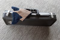 Smudge Dog attached to a musical instrument case. Handy for cleaning.
