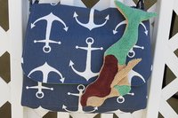 Mermaid attached to purse.