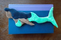 Mermaid used as bookmark for hard back book