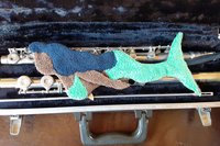 Mermaid in open musical instrument case.