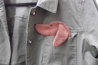 Smudge Dog peeking out of jean jacket pocket