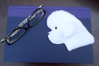 Bichon Frise used as a bookmark.