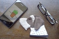 Smudge Dog with smart phone and glasses.