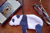 Smudge Bear with phone and glasses. Two of the items it can clean