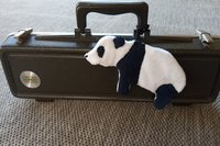 Smudge Bear attached to musical instrument case.