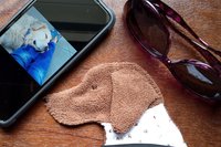 Smudge Dog with smart phone and glasses.