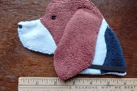 Smudge Dog shown with a ruler to show size.