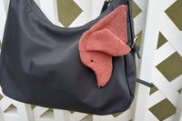 Smudge Dog attached to a handbag, always within reach.
