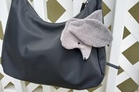 Smudge dog attached to a handbag always within reach.