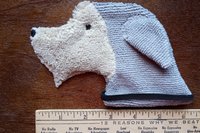 Smudge Dog shown with a ruler to demonstrate size.