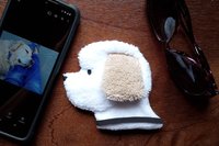 Smudge Dog with cell phone and glasses, two of the many items it can clean