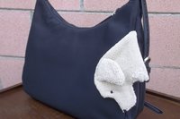 Smudge Dog attached to a handbag. Always ready and easy to find.