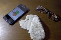Smudge Dog with smart phone and glasses.