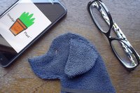 Smudge Dog shown with glasses and phone. Two of the items it can clean.