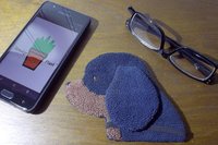 Smudge Dog with smart phone and glasses.