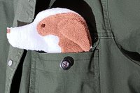 Dog shaped towel peeking out of a jean jacket pocket