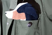 Black Tri Color Australian Shepherd Smudge Dog peeking out of the pocket of a jean jacket