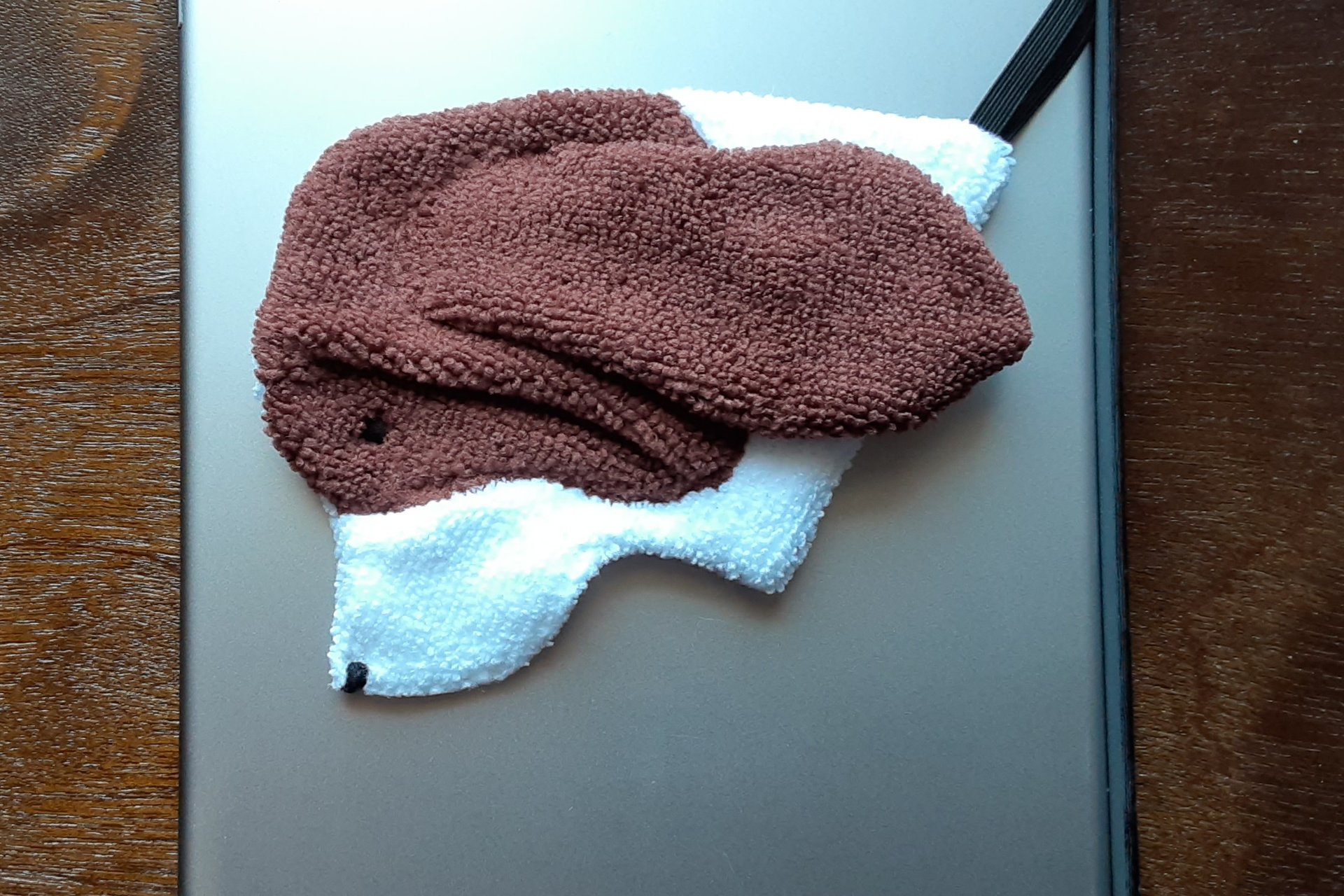 Smudge Dog attached to magnetic cover on popular tablet.