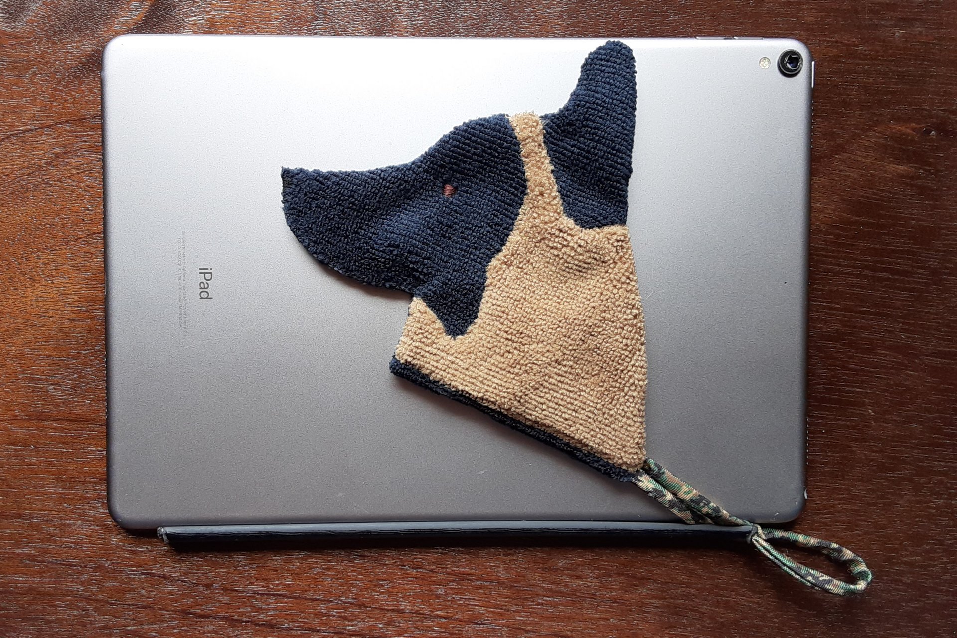 Smudge Dog attached to the magnetic cover of a popular tablet.