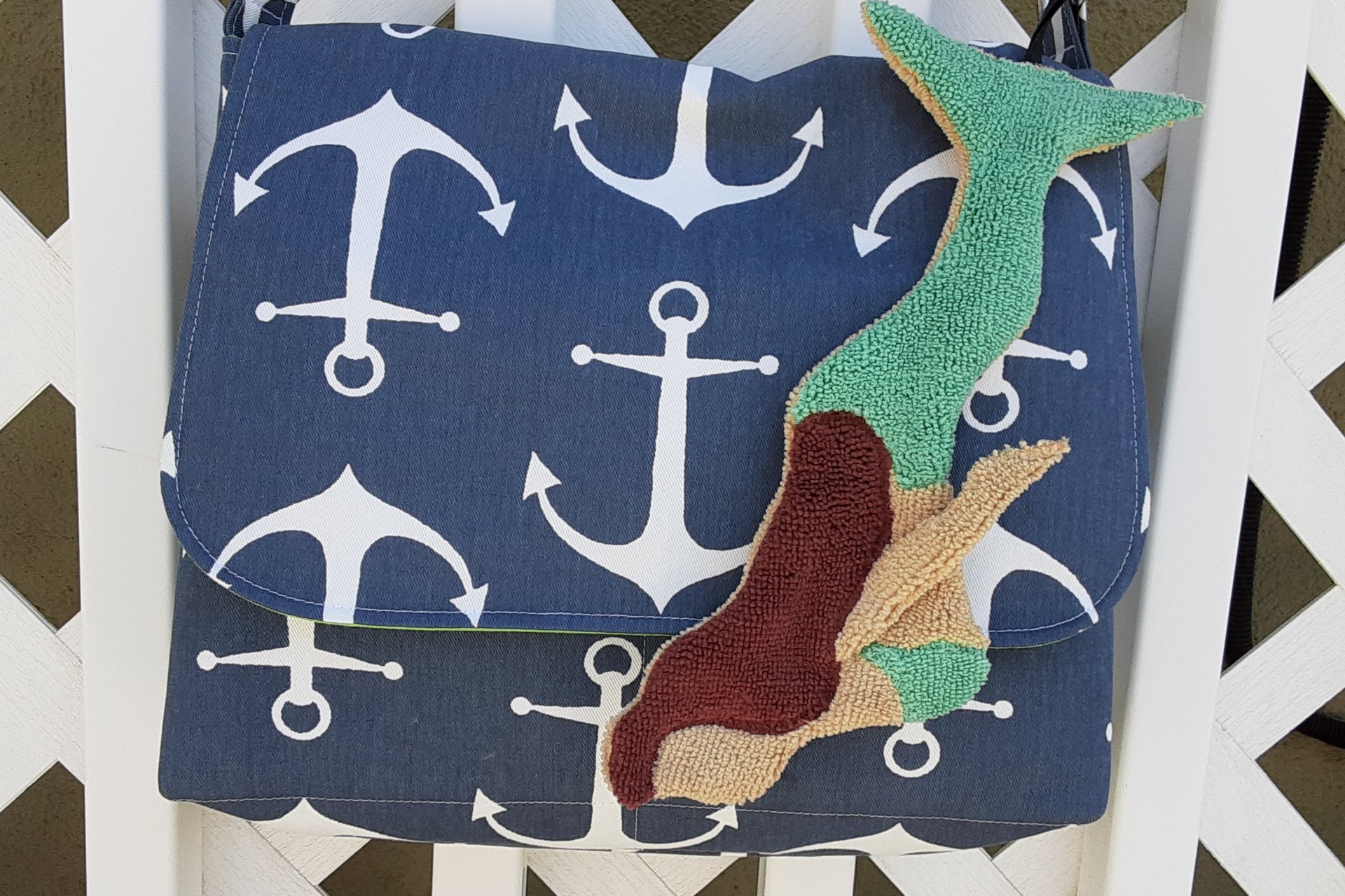Mermaid attached to purse.