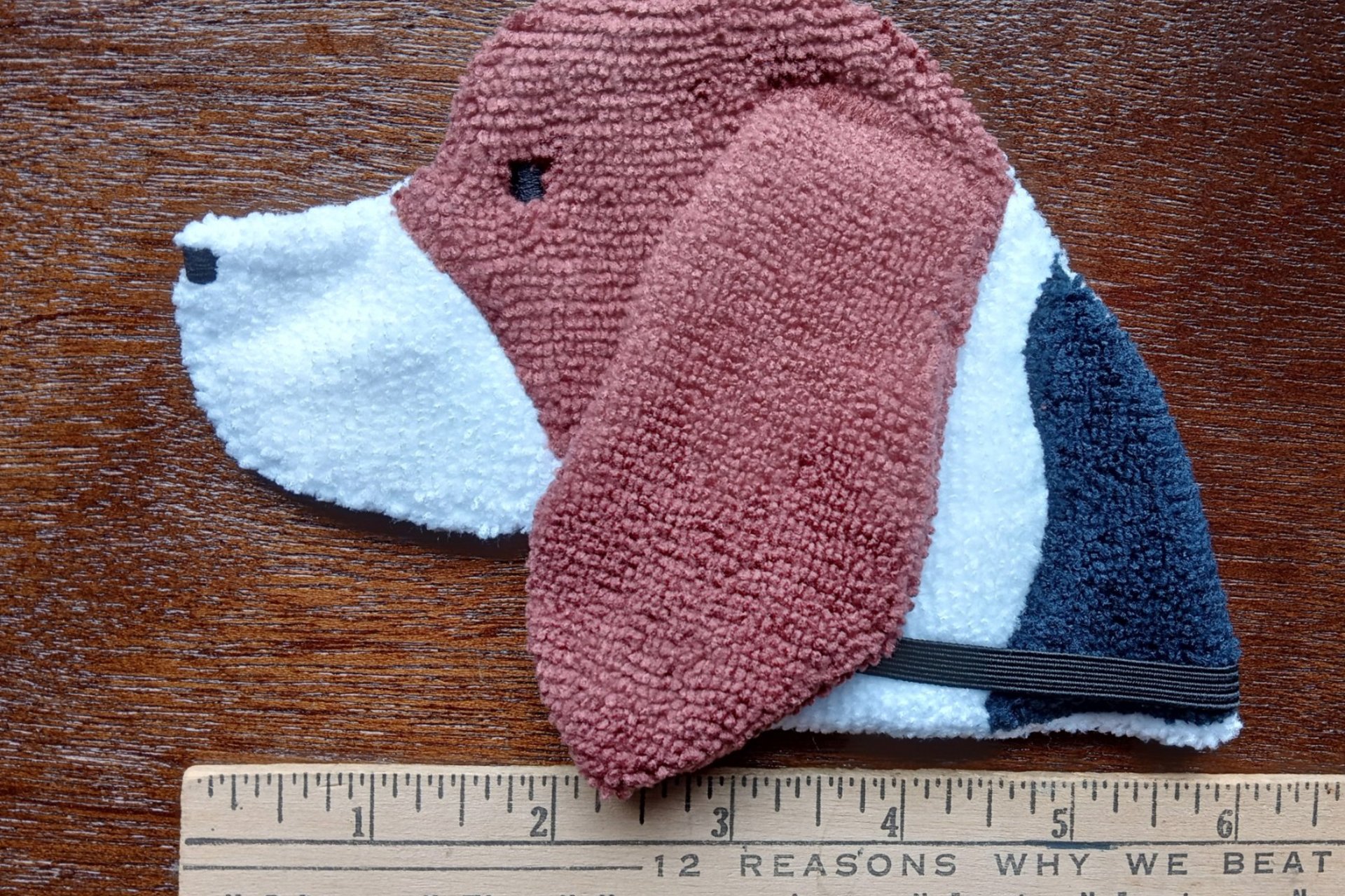 Smudge Dog shown with a ruler to show size.