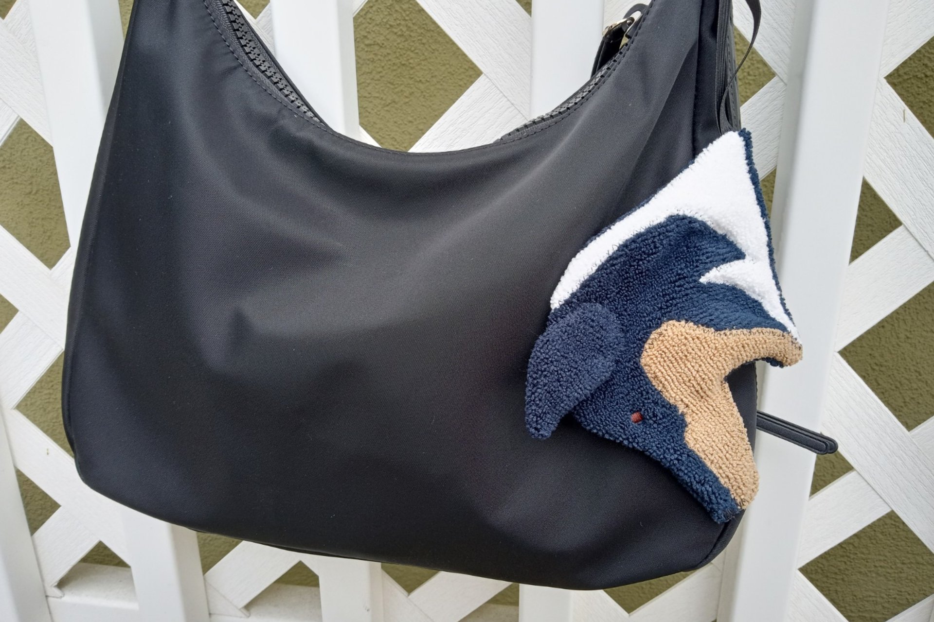 Smudge Dog attached to handbag, always easy to find and ready to clean