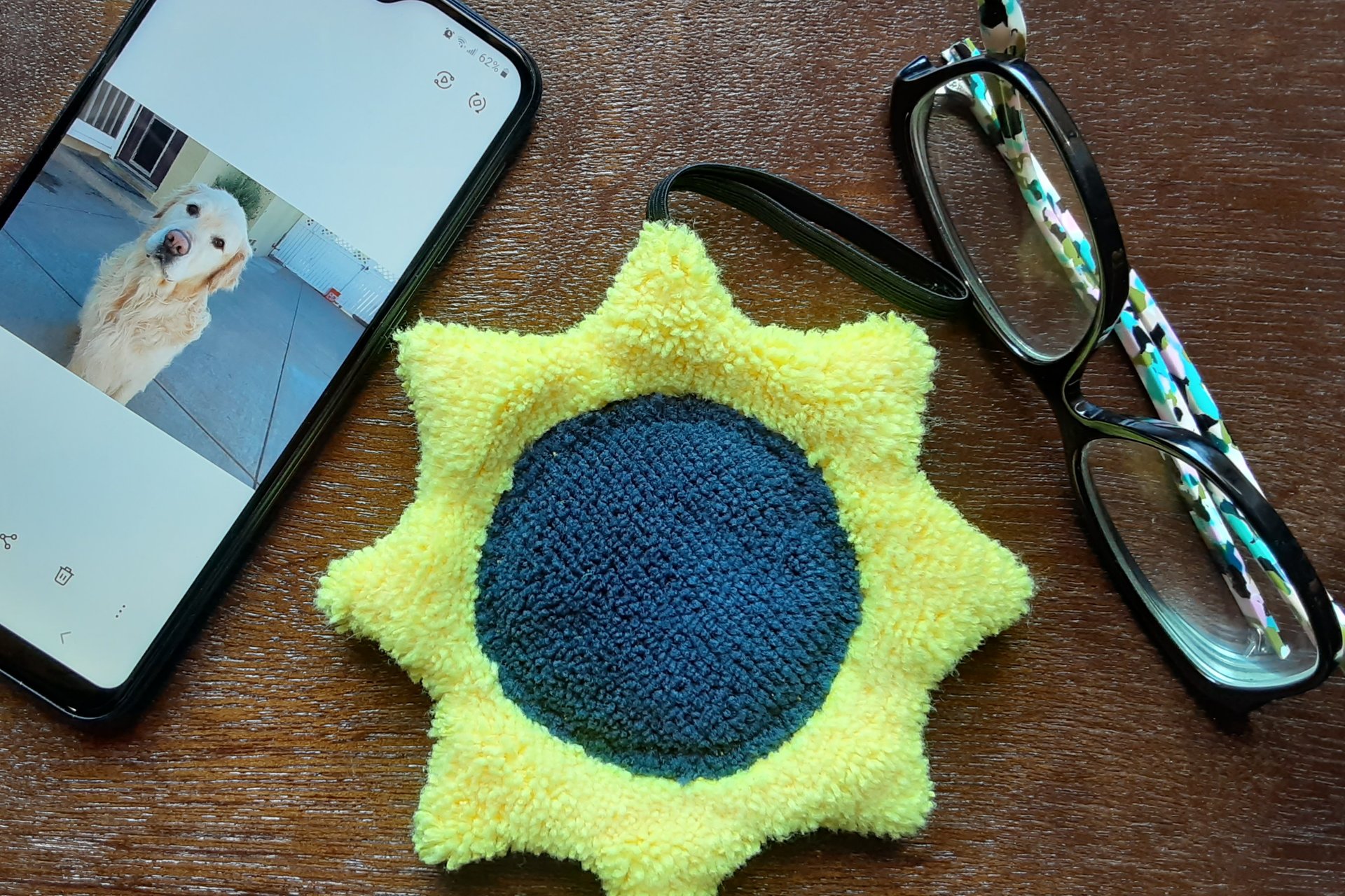Sunflower with phone and glasses. Two of the items it can clean