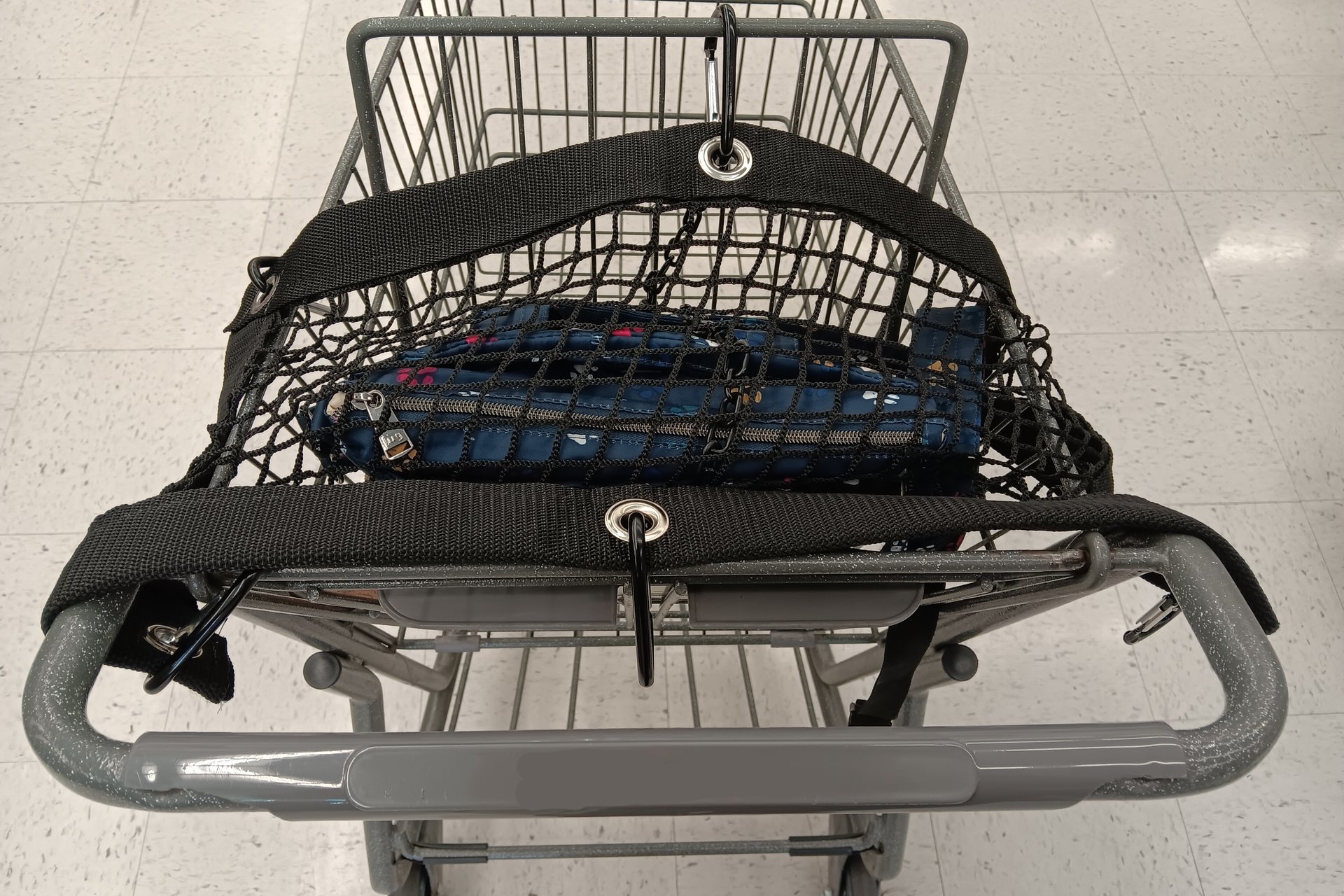 Purse and All Safety Net attached to shopping cart to protect items in child carrier section of cart