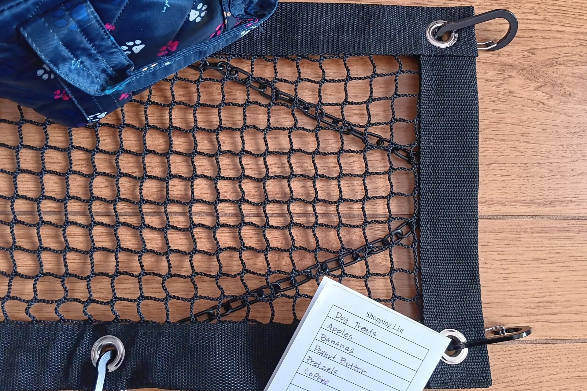 Purse and Handbag theft deterrent netting shown with hand bag and shopping list