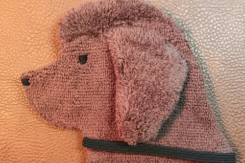 Soft, microfiber terry cloth towels cut, sewn, and made in the shape of the head of a brown Newfoundland. Little larger than palm sized. Texture of the Smudge Dog is perfect for cleaning cell phone screens, musical instruments, glasses, etc.