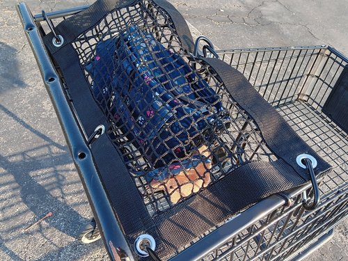 Purse and All Safety Net attached to shopping cart to protect items in child carrier section of cart